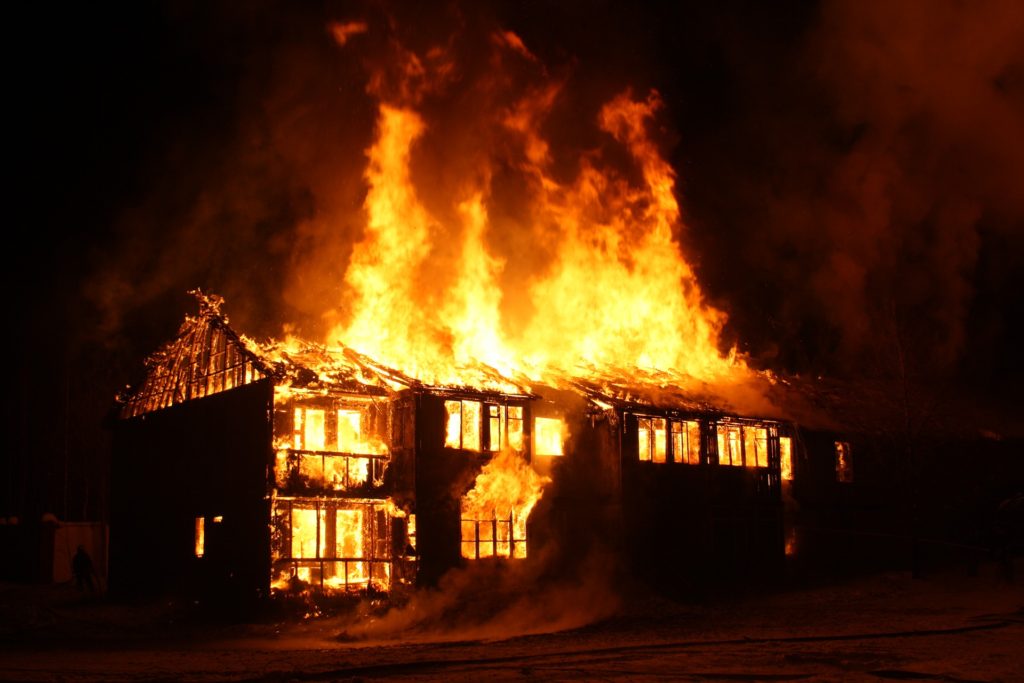 house on fire at night.