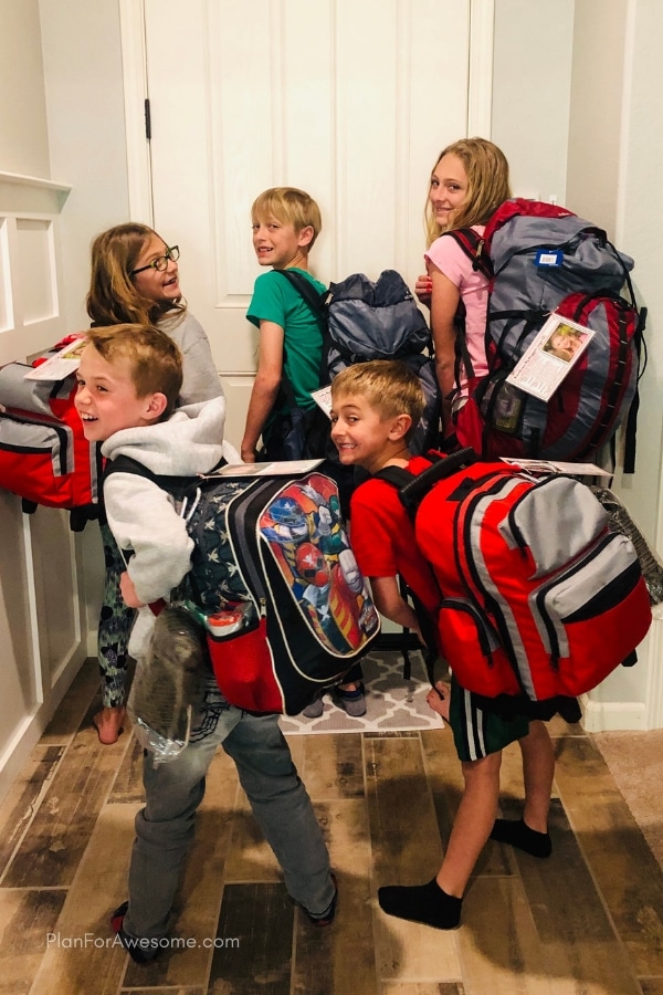 kids in a family wearing their 72-hour kit backpacks.