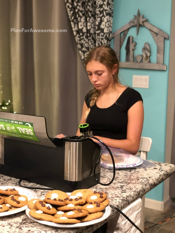 Girl vacuum sealing cookies to send overseas to deployed soldiers - #LightTheWorld 2019 - this girl is even willing to customize the flyer FOR FREE! Can't wait to do this with my ward! #LightTheWorld #LightTheWorld2019 #soldiercarepackage #freeprintables