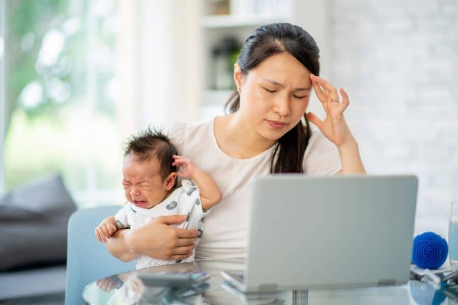 woman holding crying baby