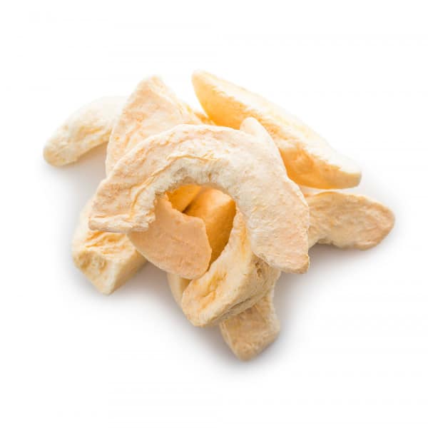 pile of freeze dried peach slices on white table.