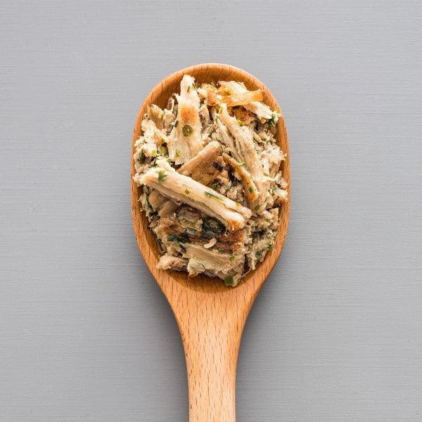wooden spoon full of pulled pork