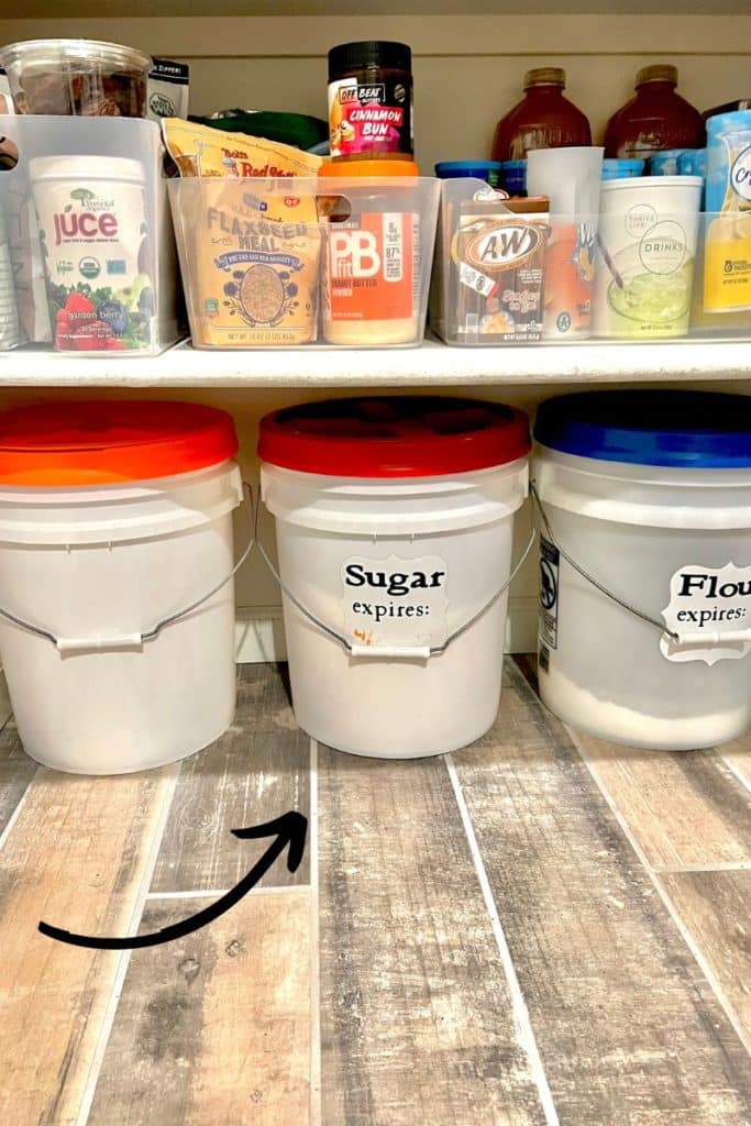 5 gallon buckets on floor of pantry