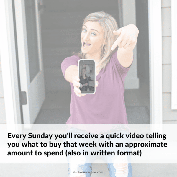 Woman holding phone showing a video in her email