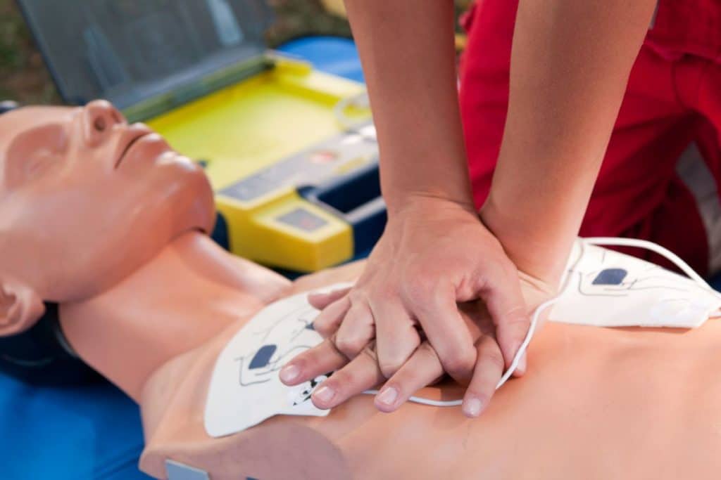 person performing CPR on a dummy