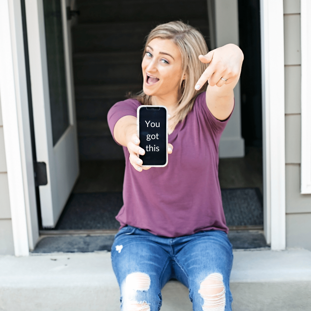 Girl pointing to phone that says, "You got this"