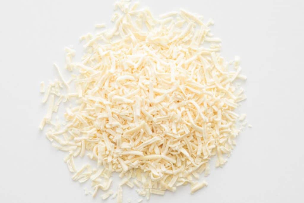 freeze dried shredded mozzarella cheese on white background