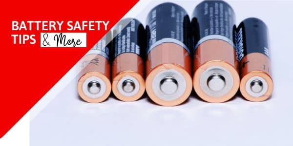 row of batteries on white surface with red triangle and text battery safety tips & more