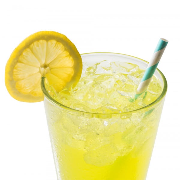 glass of lemonade with a lemon slice on the rim and a straw