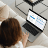 woman sitting on sofa using info hub fillable pdf on laptop