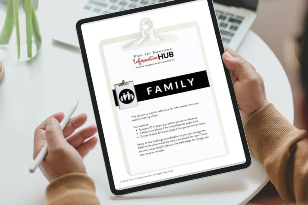 person holding tablet with title page from family information summary of information hub