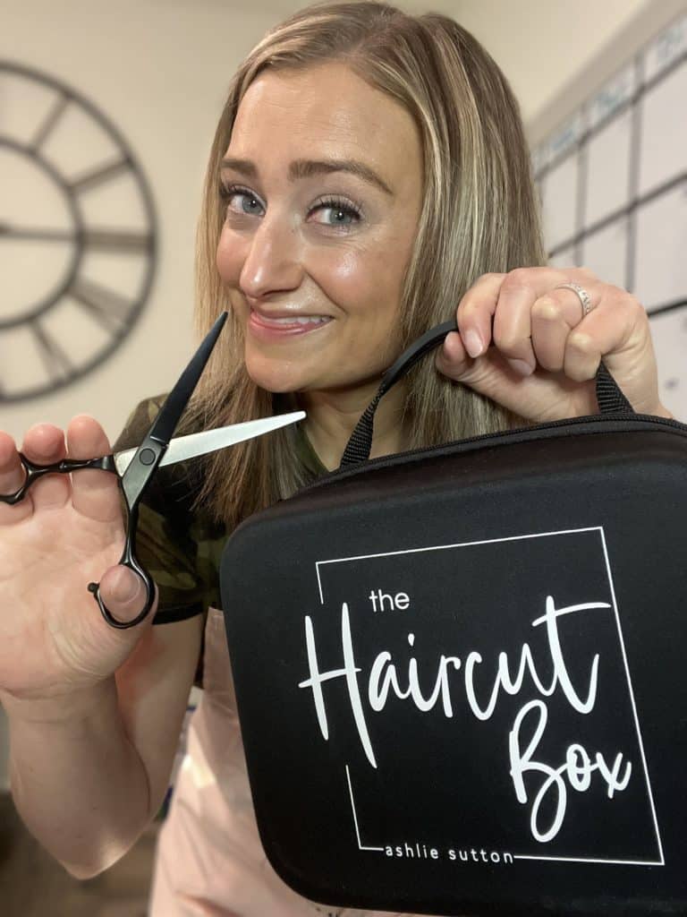 Girl holding hair cutting scissors and the Haircut Box