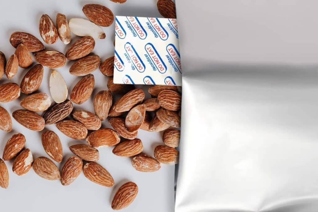 almonds and oxygen absorber packet spilling out of bag