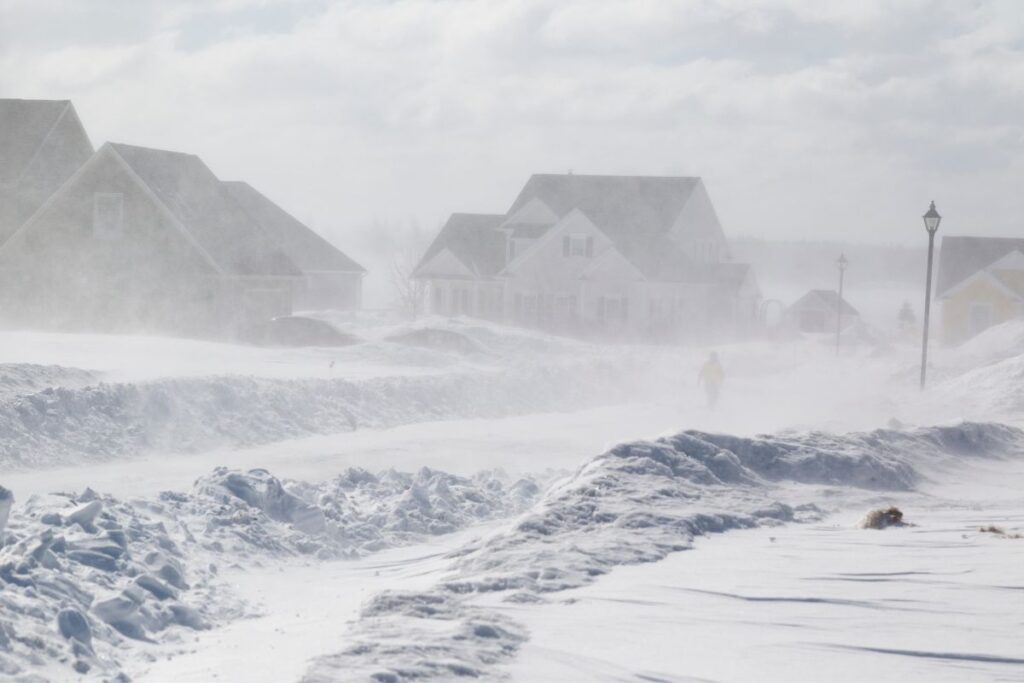 houses in the middle of a winter storm.