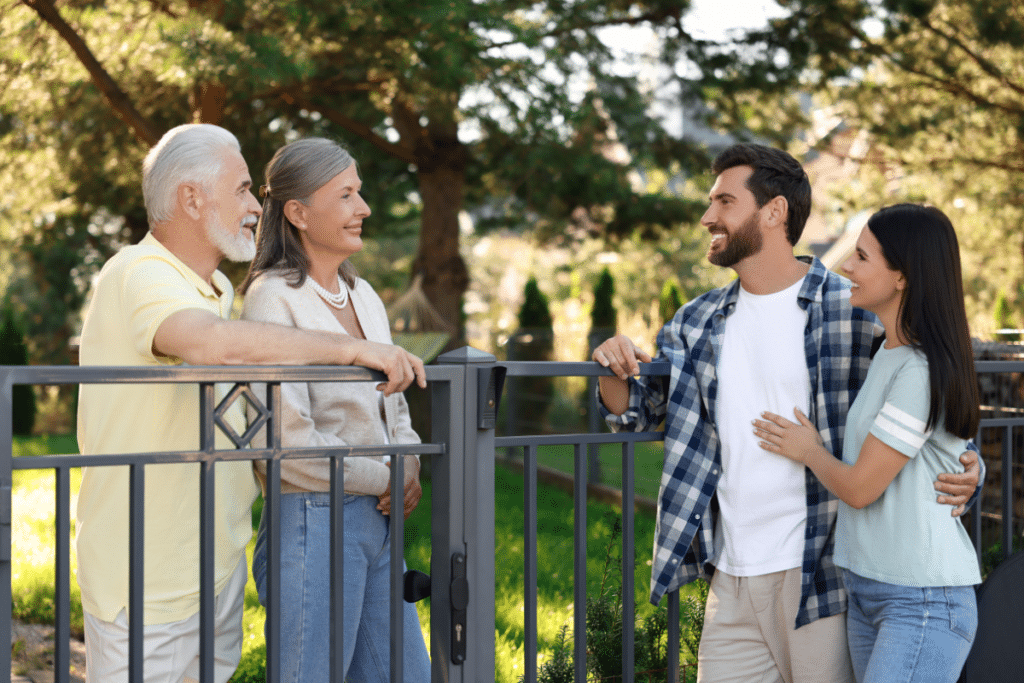 Neighbors talking across a fence.