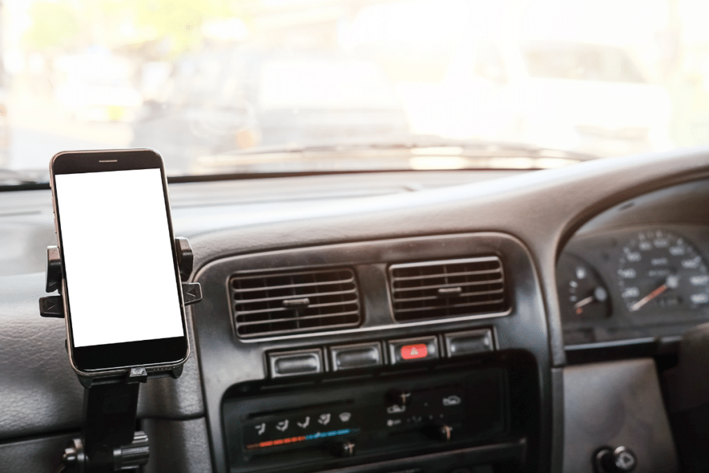 car dashboard with phone on a mount.