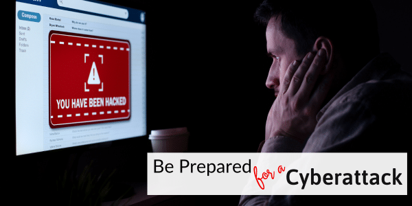 man staring at computer screen with red warning label.